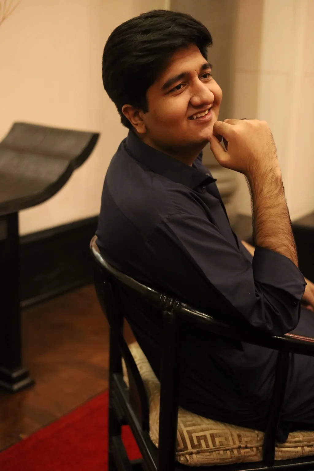 Salman Ahmad Awan smiling while seated
